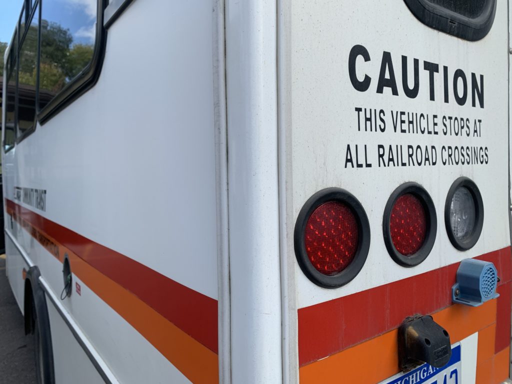 Close-up of bus caution sign for railroad crossings.